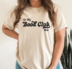 a woman wearing a t - shirt that says in my book club on the front