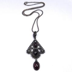 Amazing pendant with ornate 800 silver filigree cabochon garnets and seed pearls. The pendant measures 1 and ¾ inch tall by 1 and ¼ inch wide. It is on a more modern sterling silver box chain that measures 17.5 inches long. Pendant is marked 800, chain is marked 925 Italy. Excellent condition, very light wear for the age c. 1910. Antique Silver Cabochon Necklace, Black Filigree Pendant Jewelry, Ornate Silver Cabochon Necklace, Ornate Garnet Filigree Jewelry, Ornate Filigree Garnet Jewelry, Vintage Filigree Pendant Brooch, Antique Garnet Pendant Necklace, Carved Shell, Cameo Brooch