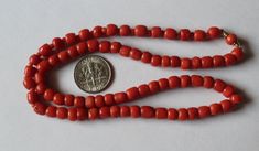 -Antique 14k Gold Natural Dark Orange Coral Beaded Necklace -Total length: 18.75 in -Bead size: about 6 mm x 5 mm -Spacer size: 2 mm -Total weight: 19.6 g -Tested 14k -Beads are barrel shape Vintage Red Coral Round Bead Necklace, Hand-strung Red Coral Beaded Necklace For Gifts, Polished Red Coral Gold Beads, Single Strand Red Coral Round Beads, Coral Beads Necklace, Unique Hand-strung Red Coral Necklaces, Coral Earrings, Coral Beads, Live Lokai Bracelet