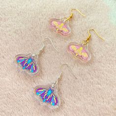 Multicolour & Rosie Maple moth earrings! 🌸 1 inch in size.  Note: Nickel free hooks! Silver plated Novelty Multicolor Earrings With Ear Wire, Whimsical Iridescent Earrings With Ear Wire, Handmade Multicolor Kawaii Earrings, Kawaii Multicolor Dangle Earrings, Cute Iridescent Earrings For Gift, Multicolor Dangle Earrings In Kawaii Style, Multicolor Butterfly Charm Earrings As Gift, Handmade Kawaii Silver Earrings, Handmade Silver Kawaii Earrings