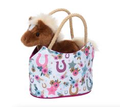 a stuffed horse in a purse on a white background