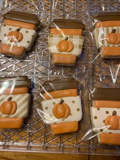 some cookies are wrapped in cellophane and have pumpkins on them for decoration