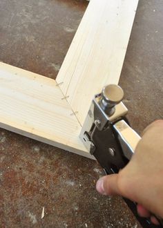 a person is using a pair of pliers to cut up a piece of wood