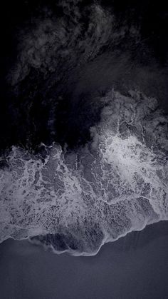 an aerial view of the ocean with waves