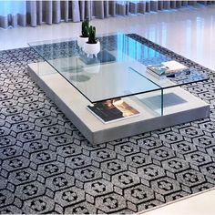 a glass coffee table sitting on top of a rug