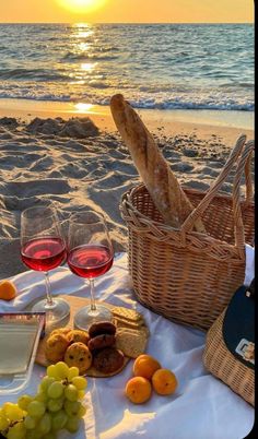 a picnic on the beach with wine and bread