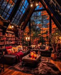 a living room filled with lots of furniture under a skylight in the middle of a forest