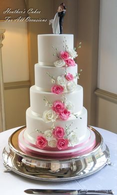 a wedding cake with pink and white flowers on it