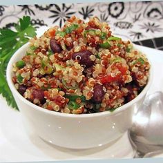 a white bowl filled with food on top of a table