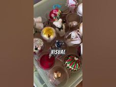 an assortment of christmas ornaments are shown in plastic cups with the word visual on them