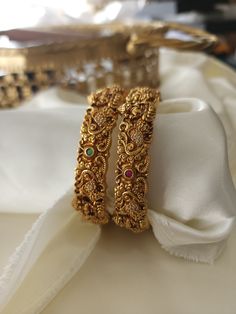 This pair of Indian bangles are perfect blend of modern luxury and traditional style. These bangles are beautifully handcrafted with utmost precision and skill. Our designers have spent hours on this piece to meet your special occasion needs. It is perfect choice for brides, pair this with your rest of the jewelry for a complete royal look. Details & Specifications: Materials used: Brass with antique matte finish Indian Bangles Gold Design, Bangles And Bracelets, Gold Jewels Design, Indian Bangles, Gold Bangles For Women, New Gold Jewellery Designs, Gold Earrings Models, Gold Bridal Jewellery Sets