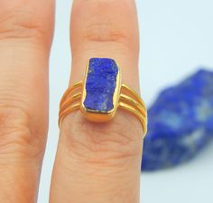 Lapis Lazuli Rectangle Rough Gemstone Ring made out of 18 karat Gold plated Sterling Silver. 100% Handmade Jewellery. LAPIS LAZULI: The sweet sounding, melodic name of this gem is composed of 'Lapis', the Latin word for stone, and 'Azula', which comes from the Arabic and means 'blue'. Historians believe the link between humans and lapis lazuli stretches back more than 6,500 years. The gem was treasured by the ancient civilizations of Mesopotamia, Egypt, China, Greece, and Rome. They valued it fo Rough Gemstone Ring, Ring Rectangle, Bezel Jewelry, Summer Rings, Latin Word, Raw Gemstone Ring, Peridot Pendant, Lapis Lazuli Ring, Blue Gems