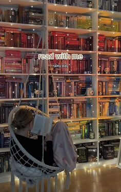 a woman sitting in a hammock reading a book on a shelf filled with books