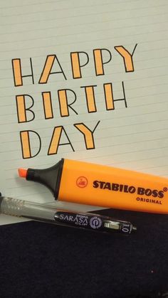 a pen and marker sitting on top of a piece of paper with the words happy birthday day written in it