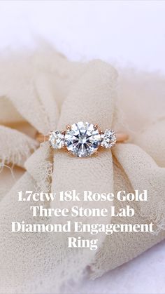 an engagement ring with three stone lab diamonds on it and the words, 17ctw 18k rose gold three stone lab diamond engagement ring