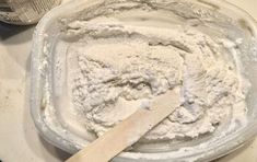 a wooden spoon sitting in a bowl filled with flour