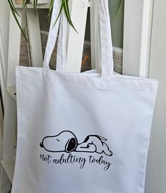 a white tote bag that says, not adulting today