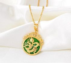 Unlock the power of positive energy with our Natural Jade Dragon Pendant Necklace, a stunning lucky charm crafted for protection and prosperity. This exquisite pendant offers: - Genuine jade for authentic beauty and rich symbolism - Luxurious gold-filled chain, perfect for everyday wear - Personalization options to layer and create a meaningful gift! At 18 inches, this necklace is designed to sit beautifully on any neckline. Our personalized name and birth flower necklace complements this necklace to make the perfect gift for the special women in your life. Layer the jade pendant with beautifully engraved necklace!  Specifications: - Necklace size: 56 cm  - Pendant size: 10x40mm Intricate Carving, Authentic Beauty, Jade Dragon, Pendant Necklace Gold, Dragon Pendant, Necklace Size, Natural Jade, Birth Flower, Engraved Necklace