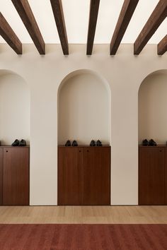 an empty room with wood floors and wooden beams on the ceiling, along with white walls