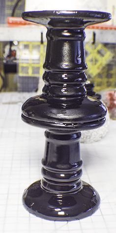 a large black object sitting on top of a white tiled floor