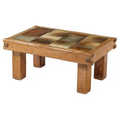 a small wooden table that is made out of wood and has different colored tiles on the top