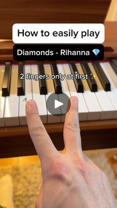 someone is playing the piano with their thumb on it's thumb and pointing to the screen