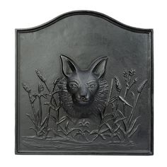 a metal plaque with an image of a fox on it's face and ears