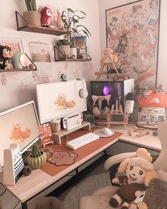 a desk with two computer monitors and stuffed animals on it