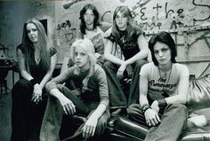 the runaways posing for a black and white photo in front of graffiti covered walls