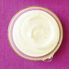 two bowls of yogurt sitting on top of a purple cloth