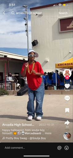 the man is walking down the street talking on his cell phone while wearing sunglasses and a red shirt