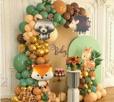 an assortment of balloons and decorations for a baby's first birthday party with woodland animals