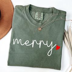 Merry Christmas Comfort Colors T-Shirt, Festive Holiday Tee, Festive Holiday Shirt, Cute Heart Merry Christmas Shirt, Christmas Gift Shirt HOW TO ORDER: Review the product images closely. Select your preferred color from the available options. Choose your T-shirt size from the dropdown menu. Customize the design or text color in the personalization box, and refer to the images for color options unless specified otherwise. Choose the number of items you wish to purchase. Add the items to your car Merry Shirt, Christmas Shirts For Women, Merry Christmas Shirts, Holiday Shirt, Cute Heart, Christmas T Shirt, Holiday Shirts, Festive Holiday, Market Place