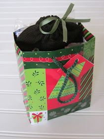 a green and red gift bag hanging from the wall with some wrapping on it's side