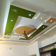 the ceiling is painted green and white with lights on it's sides, as well as an overhead fan