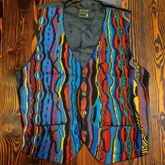 This Coogi Sweater Vest Is In Great Vintage Condition, With No Identifiable Issues. Please Review All Photos For The Condition And Ask Any Questions Prior To Purchase As There Are No Returns Or Cancellations. This Vest Is Not New, It Is A Vintage Coogi Item, So Some Wear Might Be Present. Sold As Is! Measurements Are For Guidance And Might Not Be Exact....Purchase Accordingly. Chest: 19in Length: 21in Check Out My About Me Section For Links To Additional Discounts. Fitted Multicolor Vest For Winter, Multicolor Fitted Winter Vest, Fitted Multicolor Cotton Vest, Casual Fitted Multicolor Vest, Fitted Multicolor Casual Vest, Multicolor Fitted Casual Vest, Winter Multicolor Fitted Vest, Fitted Multicolor Vest For Fall, Vintage Fitted Multicolor Vest