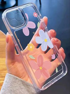 a person holding a clear phone case with flowers on the front and back cover over their hand