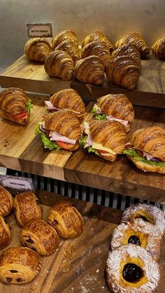 pastries and croissants are on display in a bakery