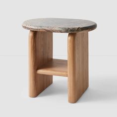 a small wooden table with a marble top and shelf on one side, against a white background