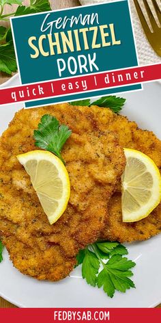 german schnitzel pork is served on a white plate with lemon wedges