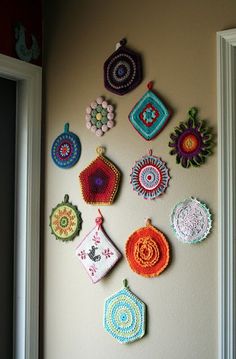 there are many crocheted ornaments hanging on the wall