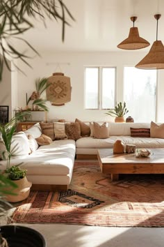 a living room filled with lots of furniture and plants