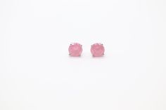 These pink opal stud earrings are perfect for adding a touch of elegance to your daytime look. They are crafted from genuine pink opal, and their unique, natural beauty is sure to turn heads. The earrings are lightweight and comfortable to wear, making them a great choice for everyday wear. Hypoallergenic Pink Jewelry For Formal Occasions, Classic Pink Sterling Silver Earrings, Classic Pink Gemstone Earrings, Feminine Pink Earrings For Anniversary, Classic Pink Cabochon Jewelry, Pink Rose Quartz Earrings Gift, Pink Rose Quartz Earrings For Gifts, Pink Round Sterling Silver Earrings, Pink Hypoallergenic Earrings For Formal Occasions