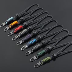 six pairs of lanyards with different colors and designs on each side, all lined up in a row