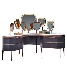 an assortment of mirrors sitting on top of a wooden table next to a dresser and mirror