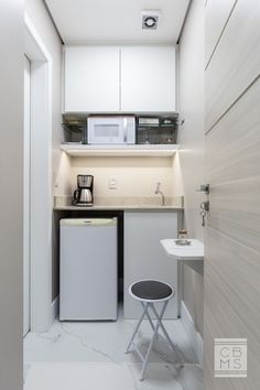 the small kitchen is clean and ready to be used as a dining area or office