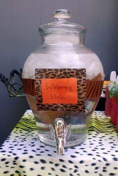 a glass jar filled with liquid sitting on top of a table