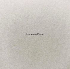 a piece of paper with the words love yourself most written in black ink on it