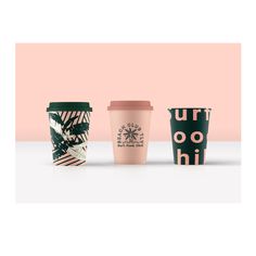 three coffee cups sitting next to each other on top of a white table with pink and green background