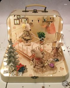 an open suitcase with christmas decorations on the inside and in it's lid, sitting on top of a table